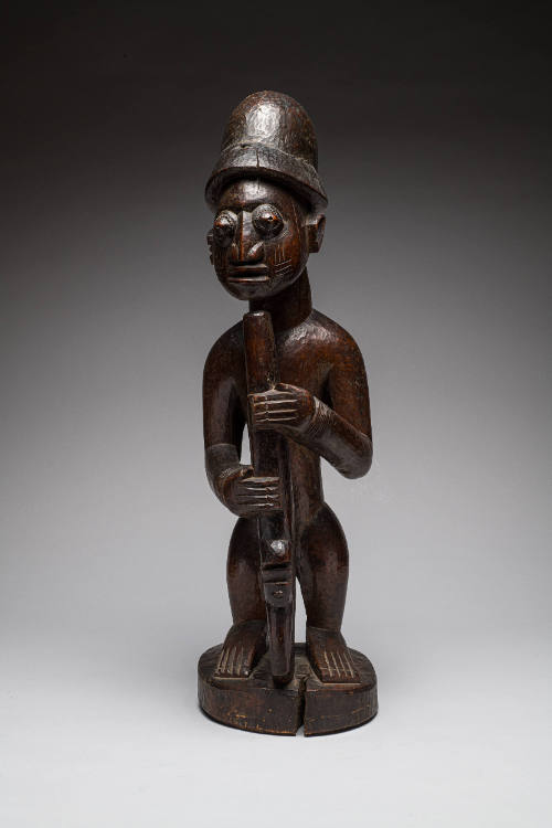 Ogun Figure holding a Gun