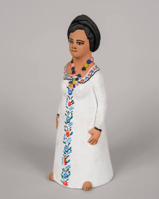 Woman in white dress wearing beads