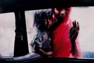 Bombay Beggar Woman and Child Peer through Car Window during Monsoon Rain